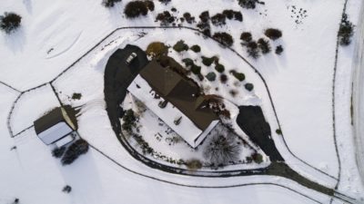 Overhead of a home in the snow below Silver Mountain