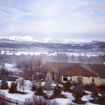 A house sits, nestled in the fog, below Silver Mountain