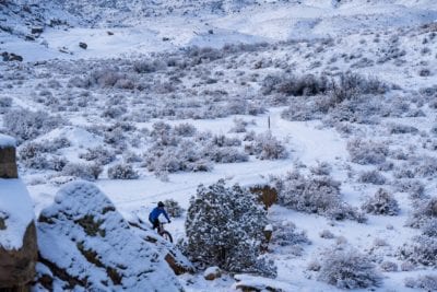 A mountain biker puts down some fresh tracks in the snow at the Lunch Loops trail system in Grand Junction, Colorado