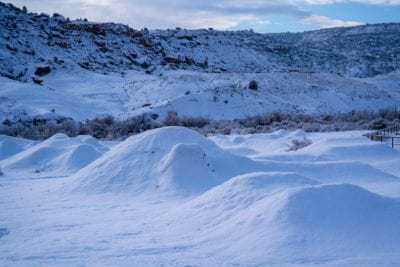 A blanket of snow covers the dirt jumps at the Lunch Loops trail system in Grand Junction, Colorado.