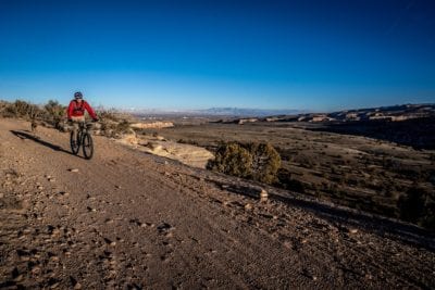 A man and his dog ride Mary’s Loop trail on a late fall ride.