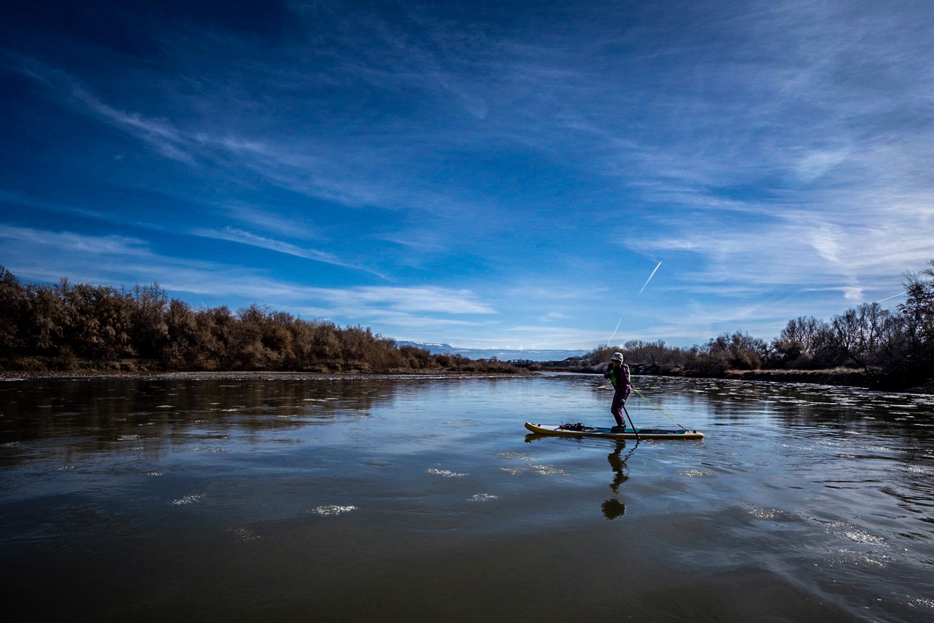 Elizabeth is reflected in the icy water of the Colorado River during a January float.