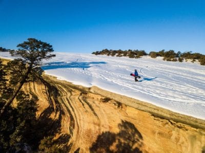 Hiking back up The Ribbon trail for another rare snowboard run.